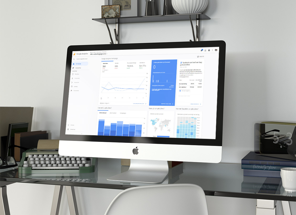 A Google Analytics dashboard on a desktop screen, with visitor charts, a world map and traffic sources.